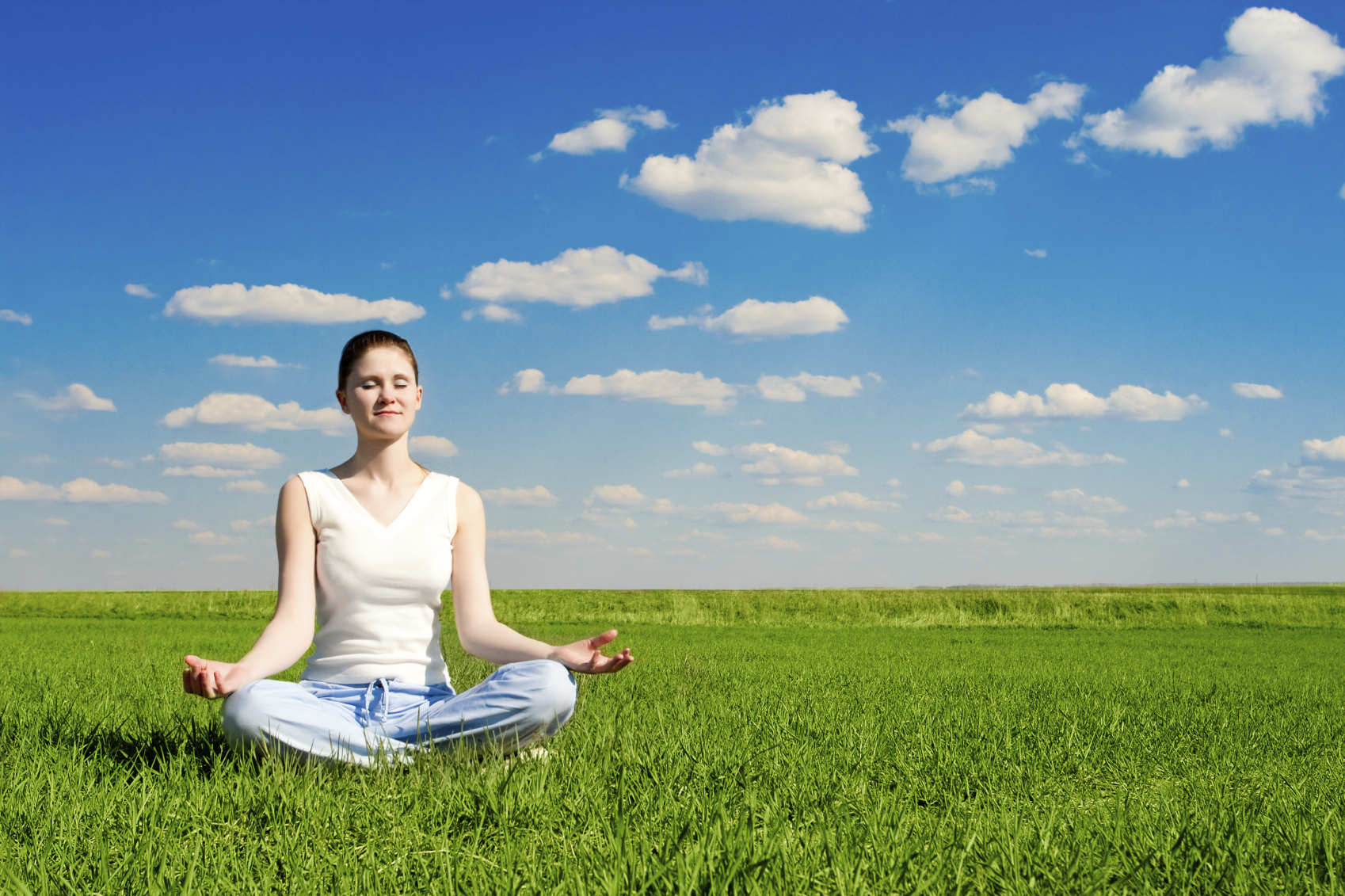 meditation on the meadow over the blue sky