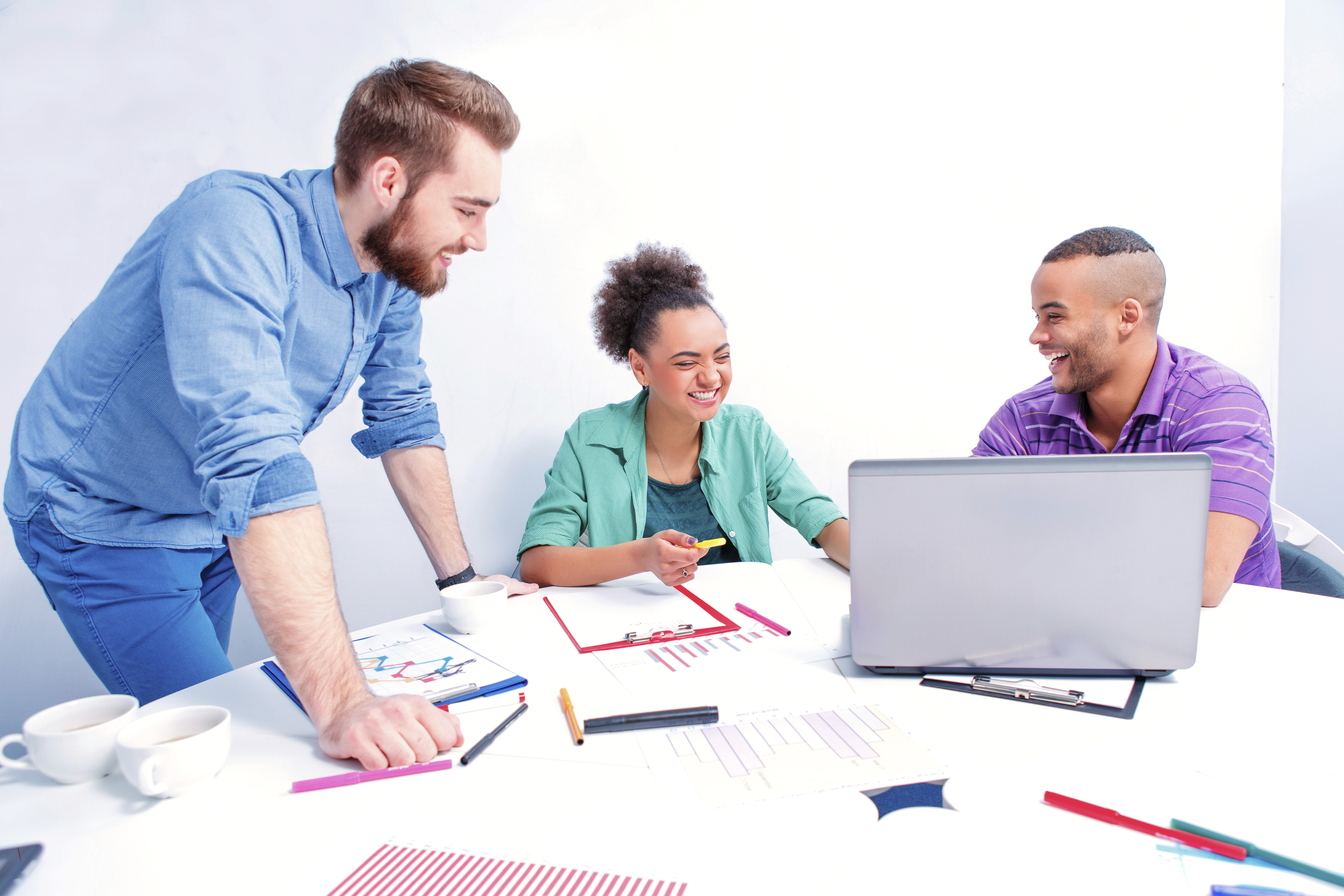 Creative professionals. Group of cheerful business people in smart casual wear discussing something while having a brain storming in the meeting room